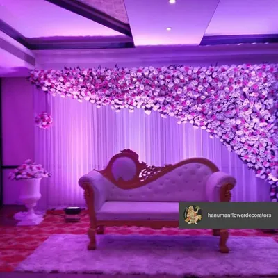 This beautiful floral stage was the centerpiece of a corporate gala. The cascading flower wall, paired with dramatic purple lighting and an elegant chaise lounge, created a perfect photo opportunity for guests.