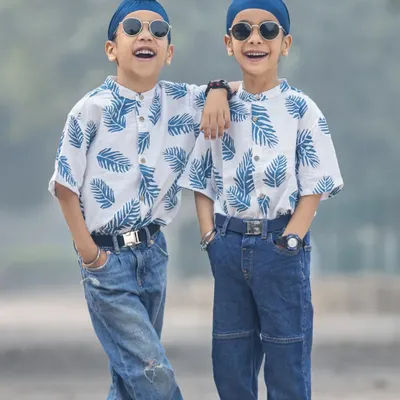 Twinning! These two brothers are looking super cool in their matching outfits during an outdoor shoot. Their confidence and bond are amazing to see.