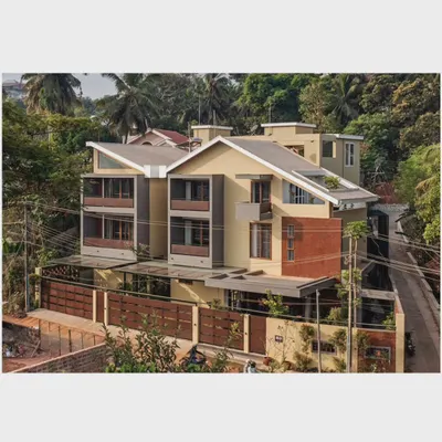 An aerial view of the 'Jodi Mane' project, showing how the two distinct homes are designed with sloping roofs and projected balconies to respond to the local climate while forming a cohesive architectural expression.