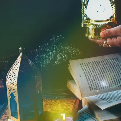 A moody and atmospheric still life with old books, lanterns, and candlelight. This shot is all about creating a feeling of mystery and nostalgia through careful styling and dramatic lighting.