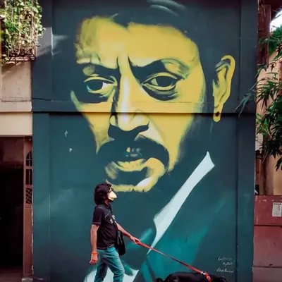 A moving tribute to the legendary actor Irrfan Khan. This mural captures his intense gaze and unforgettable presence, a permanent reminder of his contribution to cinema, found on a wall in Bandra.
