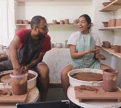 This is us, Mahanth and Shreya, in our happy place. We love the messy, joyful process of creating together, and this photo captures the fun we have bringing our ceramic ideas to life.