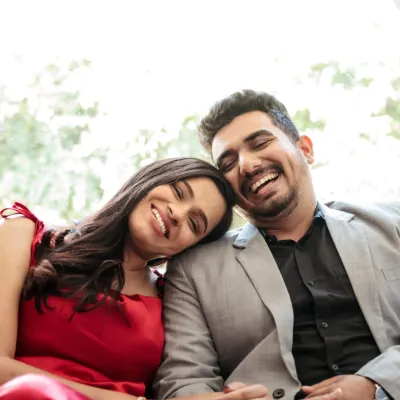 The beauty of a genuine laugh. This tight close-up captures a moment of pure, unscripted happiness and connection between the couple.