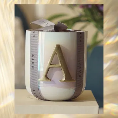 Every moment deserves a scent and a personal touch. My initial collection, featuring this iridescent candle with a gold 'A', makes for a thoughtful and elegant gift for your loved ones.