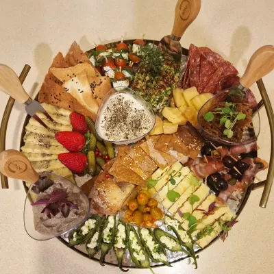 Cheese, coldcuts, crackers and fruit fill our round charcuterie platter, part of the boards we make from 12" to 32".
