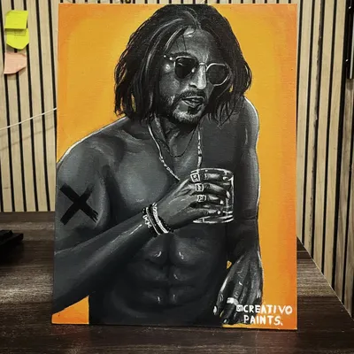 My acrylic painting of Shah Rukh Khan, displayed on a desk. This piece combines a monochrome portrait with a striking yellow-orange background.