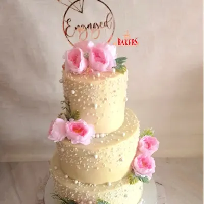 This grand three-tier engagement cake was a true showstopper. It traveled 60 km to the celebration, featuring three different delicious flavors to please every guest. I decorated it with delicate sugar pearls and fresh pink peonies for a classic, romantic look, all completely no-fondant.