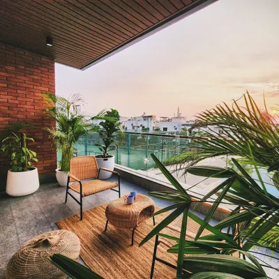 We transformed this urban balcony into a serene sunset nook. Wicker and rattan furniture, a natural jute rug, and an abundance of potted plants create a bohemian, resort-like feel. It's the perfect spot to unwind and enjoy the view.