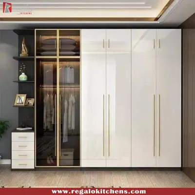 A perfect example of modern elegance. This wardrobe combines high-gloss white doors with a glass-fronted display section, complete with gold-finish handles for a touch of luxury.