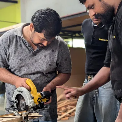 A mentor guiding a participant on the circular saw. We're right there with you, making sure you learn safely and effectively. Our goal is to build your confidence so you can tackle any project.