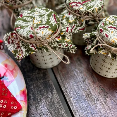 Tradition meets tomorrow in these beautifully detailed jars. The lids are covered in classic Indian block-print fabric and tied with simple jute string, a perfect blend of rustic charm and timeless design for wedding favors or festive gifts.