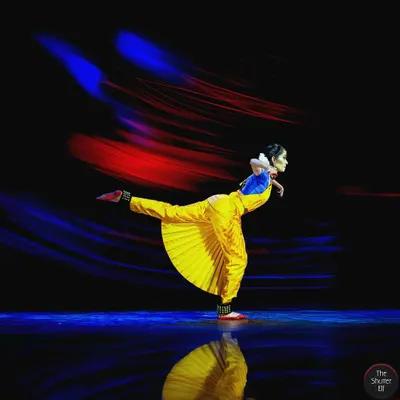 A dynamic moment captured on stage, using light painting to emphasize the energy and motion of the performance. This technique adds a layer of emotional intensity to the visual narrative.