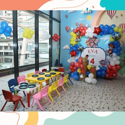 No job is too big, no pup is too small for our Paw Patrol themed party setup. We created this amazing backdrop with a balloon arch and character cutouts for Eva's 4th birthday, complete with colorful kid-sized tables ready for the little guests.