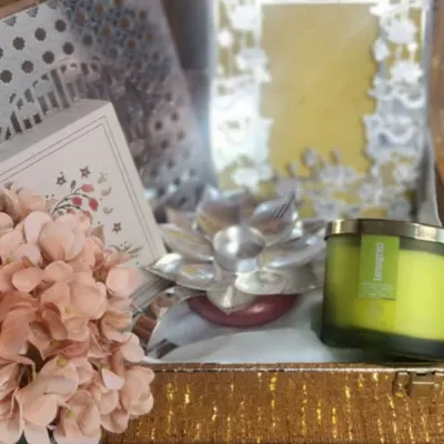Announcing our festive collaboration with EKAM, a luxury fragrance brand. This image shows a sneak peek of our limited-edition gift box, featuring a beautiful candle, a silver lotus holder, and other premium items.