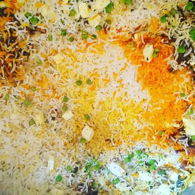A top-down view of my delicious vegetable biryani, full of fresh peas, paneer, and fragrant saffron rice.