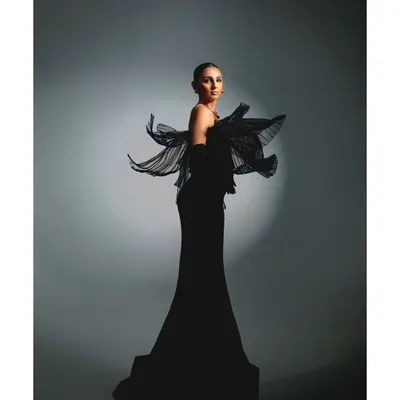 A full-length shot of Masoom Minawala for her Elle Digital cover story. The focus here is on the dramatic silhouette and the movement of the pleated fabric, creating an image of effortless grace and power.