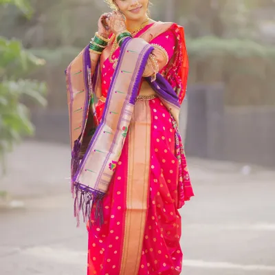 A full-length view of a stunning bride in a pink and purple Nauvari saree. I ensure the traditional drape is perfect, allowing for graceful movement while maintaining its classic form.