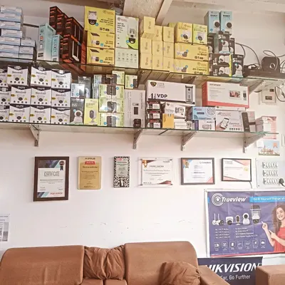 A view inside my new branch, with shelves fully stocked with the latest security products. You can also see some of my authorized partnership certificates on the wall, which are a testament to my commitment to quality.