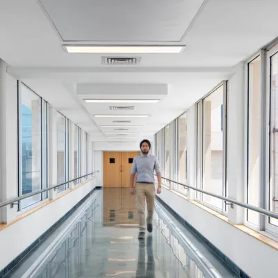 This bright, glass-lined corridor at Max Super Speciality Hospital is designed for intuitive wayfinding. The use of natural light and reflective surfaces creates a calm and restorative visual environment.