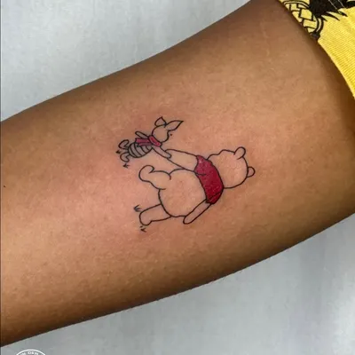 A heartwarming color tattoo of Winnie the Pooh and Piglet, symbolizing unconditional friendship and childhood innocence. This piece is a gentle reminder of comfort, loyalty, and the simple joys of life.