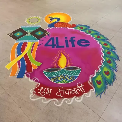 A complete view of a large-scale corporate rangoli created for Diwali. The design incorporates the company logo, a central diya, a kandil, and a border of peacock feathers, all in a bright, welcoming color palette.