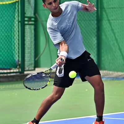 This action shot captures the intensity and focus of a player dominating the point. This is the kind of aggressive, on-the-front-foot tennis we train for.
