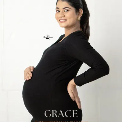 A simple, elegant portrait in a classic black dress. The focus is entirely on the mother-to-be and her beautiful silhouette. This style is timeless and chic.