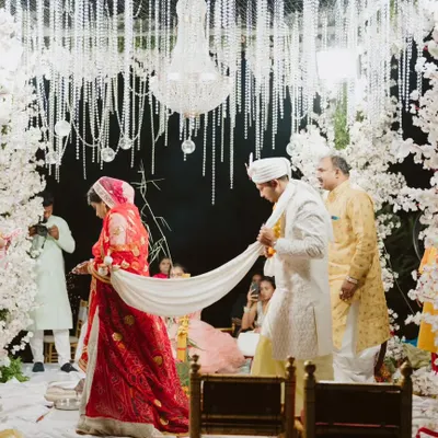 The sacred 'pheras' are the heart of the ceremony. I designed this breathtaking mandap with arches of white cherry blossoms and a ceiling of hanging crystals and florals, creating a magical, ethereal space for the couple to take their seven steps.