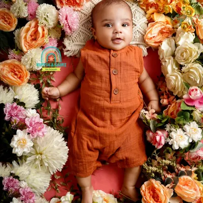 Two months old is a magical time when they start to interact more. We captured this baby's bright-eyed curiosity in a beautiful floral nest.