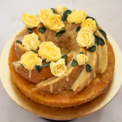 A dressed-up bundt cake for a Jane Austen themed party! This soft vanilla bundt with a crunchy sugar glaze and buttercream roses is perfect for an elegant celebration.