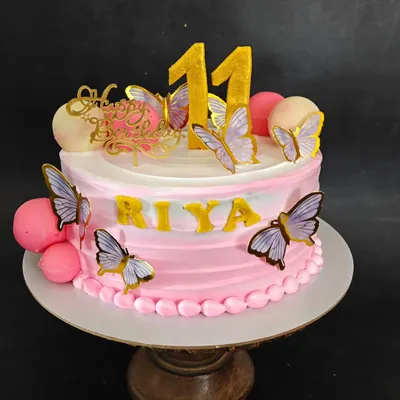 A sweet and simple butterfly cake in shades of pink, perfect for an 11th birthday.