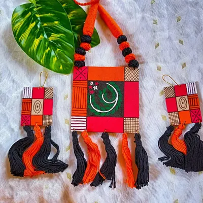 This is another view of my geometric patchwork necklace. The combination of hand-painted fabric, thread tassels, and a vibrant color palette makes it a standout piece of contemporary handcrafted jewelry.