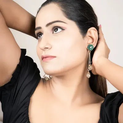 A lifestyle shot for a jewellery brand, showing how the earrings look when worn. This helps customers visualize the product in a real-life context.
