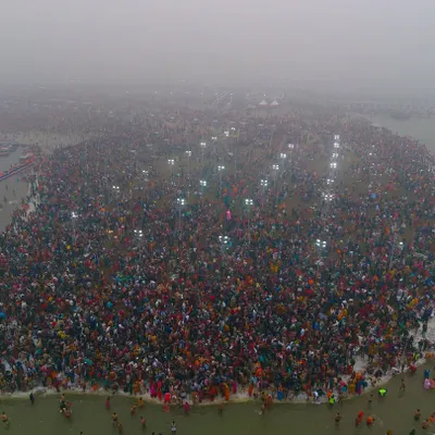 An early morning at the Mahakumbh Mela during the first holy dip, or Paush Purnima Snan. The fog and the lights create a mystical atmosphere over the massive crowd at the Sangam.