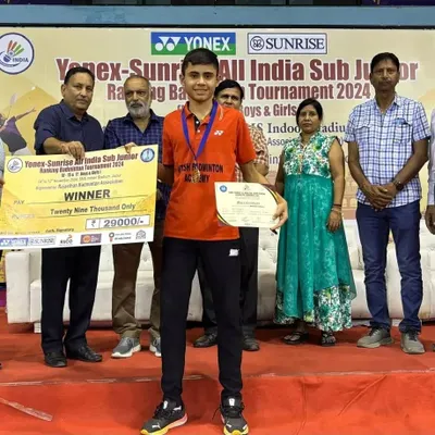 Celebrating Dev's gold medal win at the Yonex-Sunrise All India Sub Junior Ranking Tournament 2024. He is seen here receiving his winner's certificate and prize money.