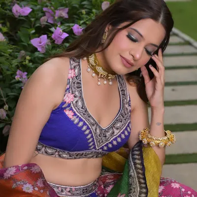 Not your regular mehendi vibes! For this look, we went with a colorful smokey eye using shades of blue and green to match her vibrant Rajdeep Ranawat lehenga.