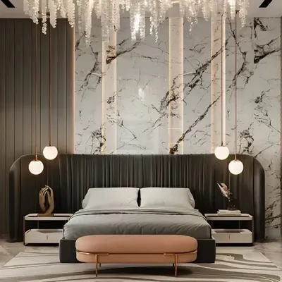 A masterclass in luxury, this bedroom features a floor-to-ceiling marble accent wall, a plush upholstered headboard, and a stunning crystal chandelier. The design uses a mix of textures and lighting to create a truly opulent space.