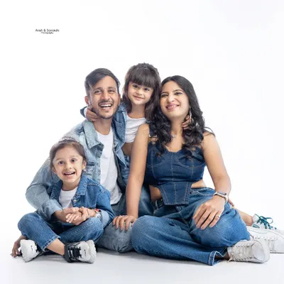 A picture of pure happiness! We had a super fun studio session with this adorable family, capturing their joyful energy in a classic denim-and-white theme.