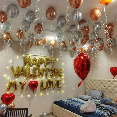 Make Valentine's Day unforgettable with a room full of love. This setup features "HAPPY VALENTINE MY LOVE" foil balloons, surrounded by elegant rose gold and silver metallic balloons and fairy lights for a magical evening.