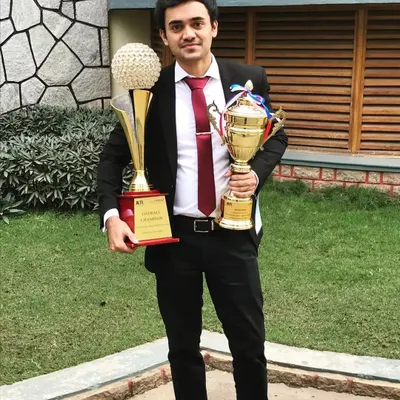 This photo takes me back to my law school days. I once feared public speaking, but facing that fear led to winning these 'Winner' and 'Overall Champion' trophies in a moot court competition, shaping the confident advocate I am today.