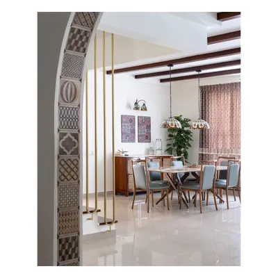A view from the foyer of the 'Spanish Country Home,' looking into the dining area. The design transformed an old penthouse into a cozy casa with Spanish flair, blending Mediterranean sensibilities with Indian touches.