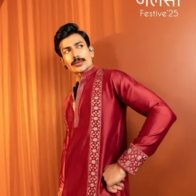 A striking shot from the Kaaj Button Studio 'Jalsa Festive' campaign. The grooming is clean and sharp, focusing on even skin tone and defining the model's strong features to suit the rich, festive attire.