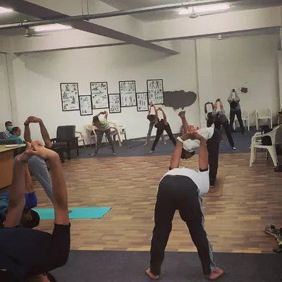 Our shooters engaging in yoga stretches designed to improve flexibility and core strength, which are vital for maintaining a stable shooting stance for long durations.