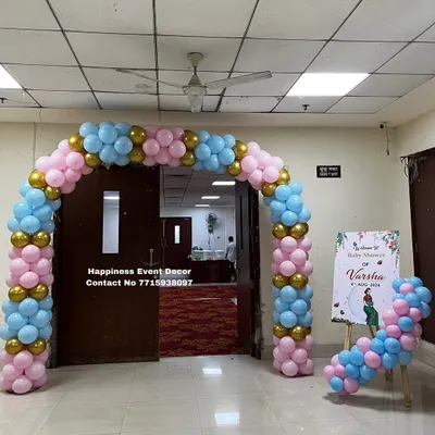 I created this balloon arch for the entrance of a baby shower. The pink, blue, and gold colors are perfect for a gender-neutral theme, and the welcome sign on the easel adds a personal touch.