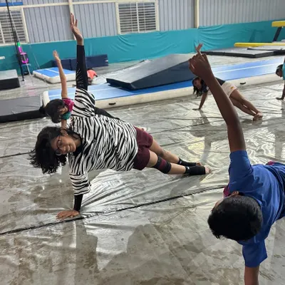Building a strong core is fundamental. Our students work on exercises like this side plank, which is essential for stability in all gymnastic movements.