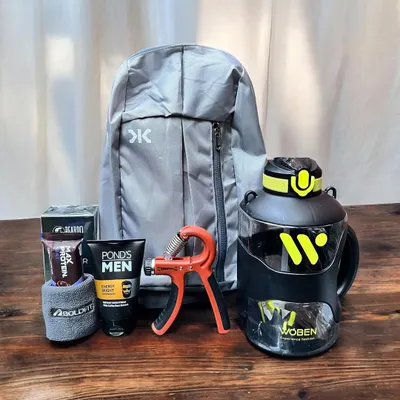 A perfect gift for the fitness enthusiast in your life. This hamper includes a lightweight backpack, a large water bottle, a hand gripper, protein bars, and men's grooming essentials.