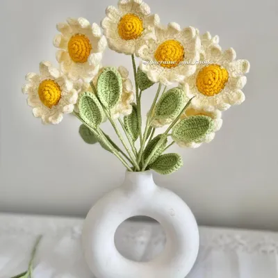 A full bouquet of my sweet crochet daisies arranged in a white vase. Their classic white and yellow look brings a fresh and simple charm to any room.