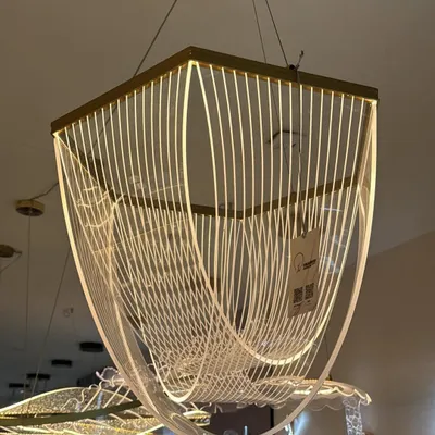 This modern chandelier uses flowing lines of light to create a sense of movement. It's a true work of art that looks stunning over a large dining table or in a high-ceiling entryway.