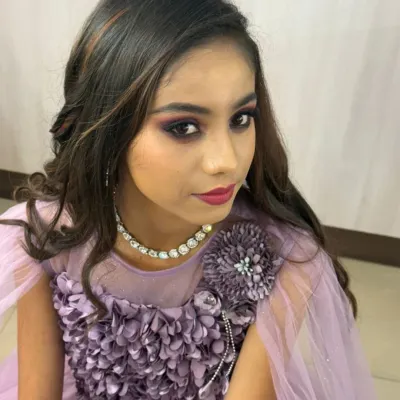 A "Glam Doll" evening party makeup look. This style features a shimmery pink smokey eye, voluminous lashes, and soft curls, perfect for a cocktail party or formal event.