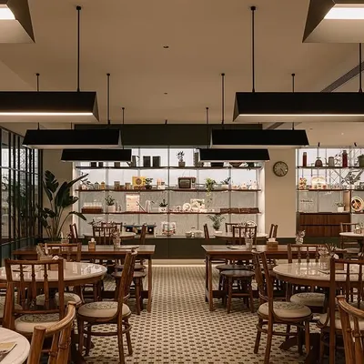 I designed the dining space to feel open, comfortable, and a bit old school, just like a traditional Kopitiam. The tiled floors, wooden furniture, and warm lighting are all meant to make you feel at home.
